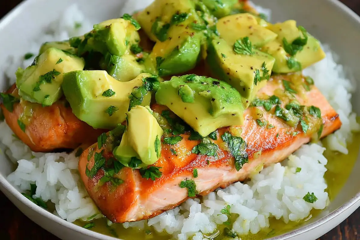 salmon-and-avocado-rice-bowl-featured Close-up of a salmon and avocado rice bowl with colorful vegetables and creamy sauce