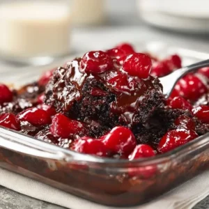 Delicious Black Forest Dump Cake topped with cherries and whipped cream
