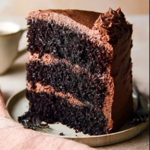 Ina Garten's delicious chocolate cake topped with rich frosting and garnishes