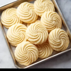 Delicious soft butter cookies on a plate, freshly baked and golden brown.