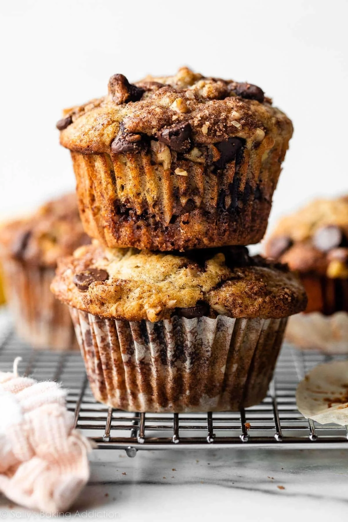 Banana chocolate chip muffins topped with cinnamon streusel on a wooden table