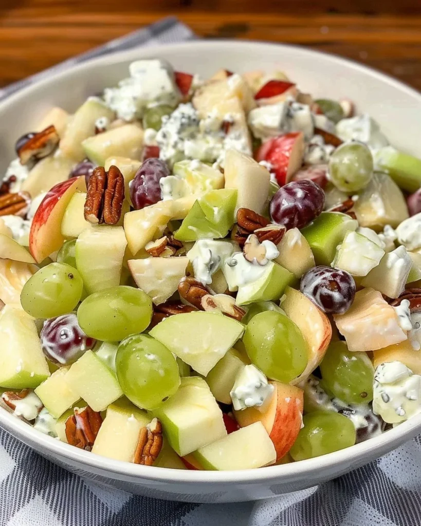 Bowl of colorful fruit salad topped with creamy sour cream dressing